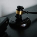 Close-up of a wooden gavel on a desk, symbolizing justice and legal authority.